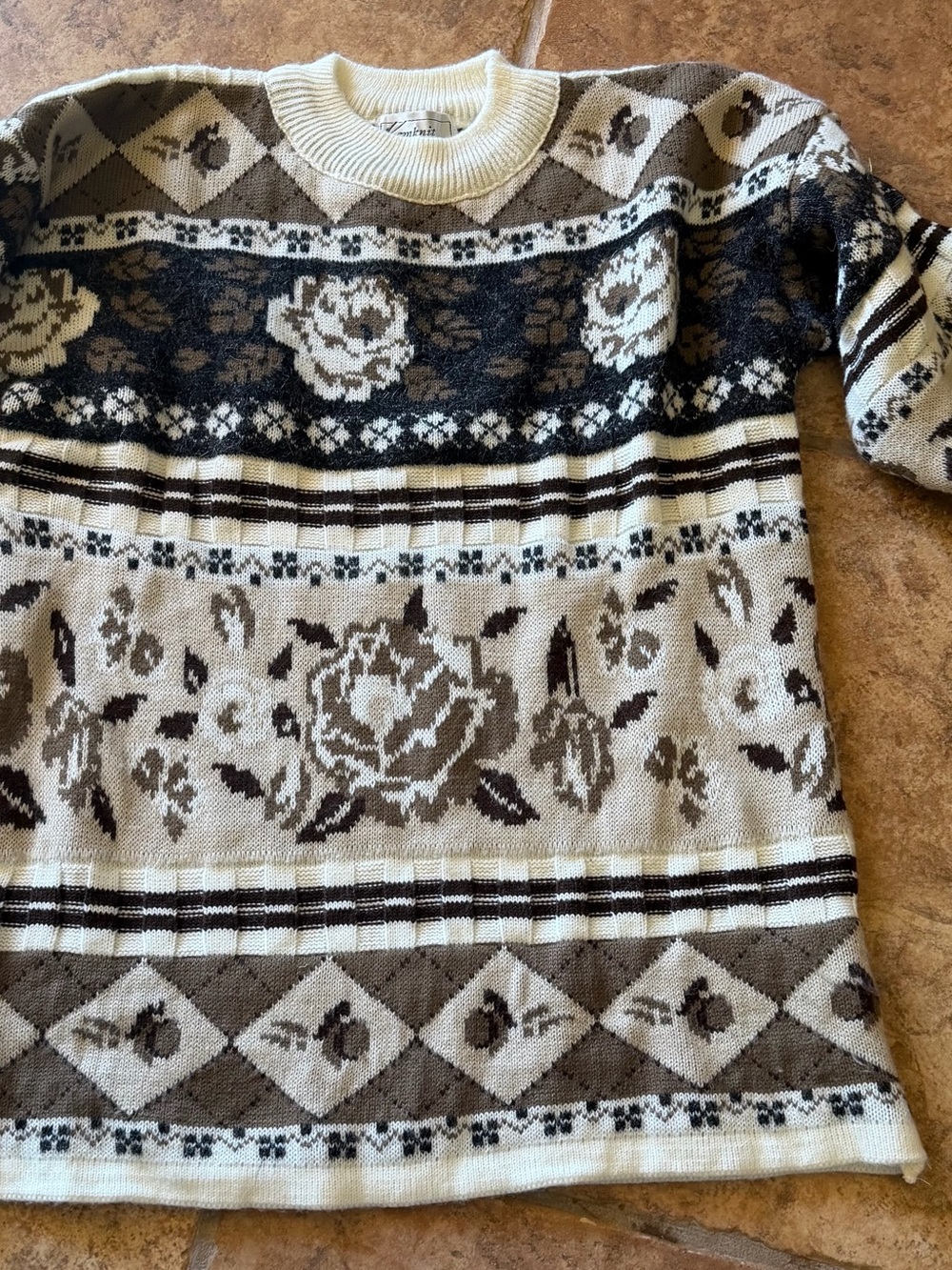 Vintage knit sweater with floral and geometric patterns.